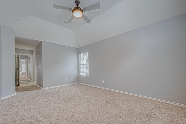 unfurnished room featuring ceiling fan, light colored carpet, and lofted ceiling