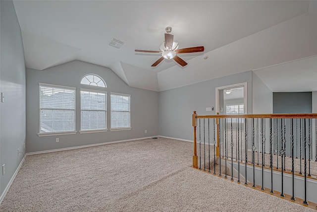 carpeted empty room featuring ceiling fan and lofted ceiling