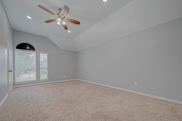 carpeted empty room featuring ceiling fan and lofted ceiling