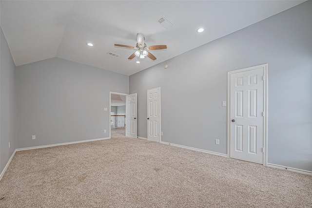 empty room featuring ceiling fan, carpet, and vaulted ceiling