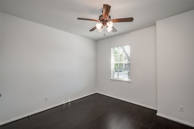 spare room with dark wood-type flooring and ceiling fan