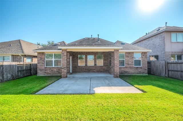 back of property with a patio and a yard