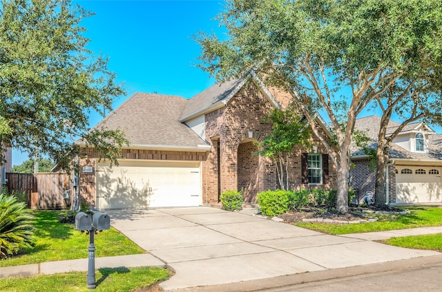 view of front of property with a front yard and a garage