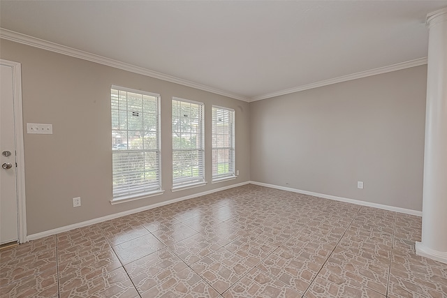 tiled spare room featuring ornamental molding and decorative columns