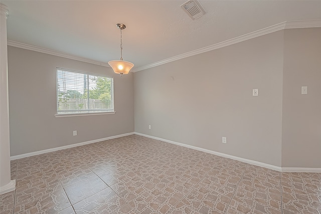 spare room featuring ornate columns and ornamental molding