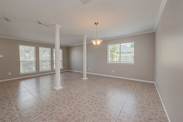 spare room with ornate columns, ornamental molding, and tile patterned floors