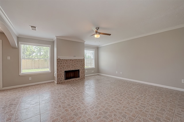 unfurnished living room featuring crown molding, ceiling fan, and a tile fireplace