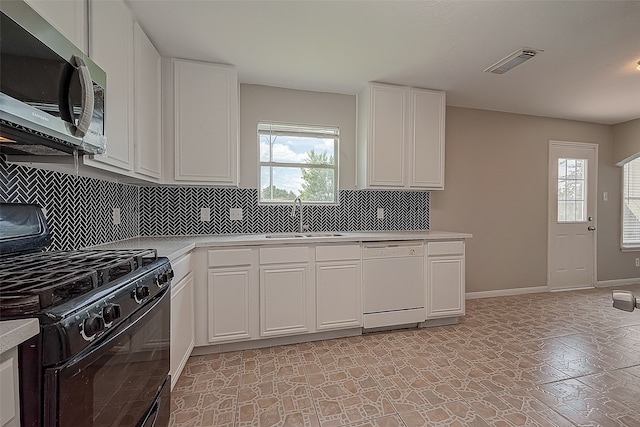 kitchen featuring a wealth of natural light, black gas range, white cabinetry, and dishwasher