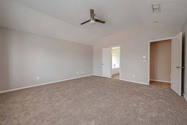 unfurnished bedroom with lofted ceiling, light colored carpet, ensuite bath, and ceiling fan