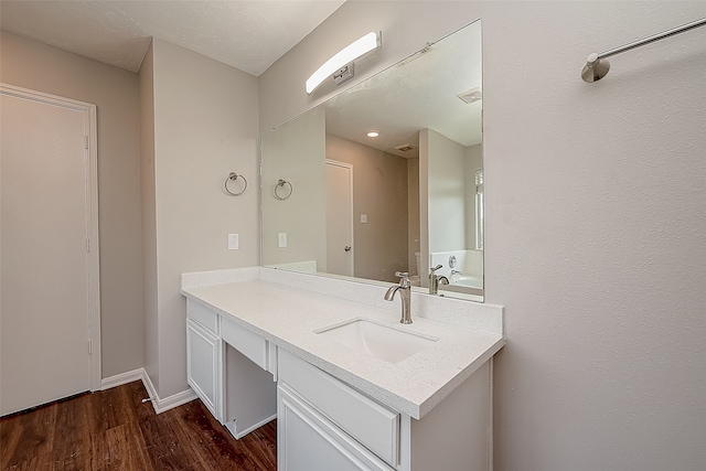 bathroom with vanity and hardwood / wood-style floors