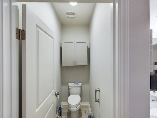 bathroom with toilet and tile patterned floors