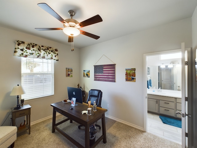 carpeted home office featuring sink and ceiling fan