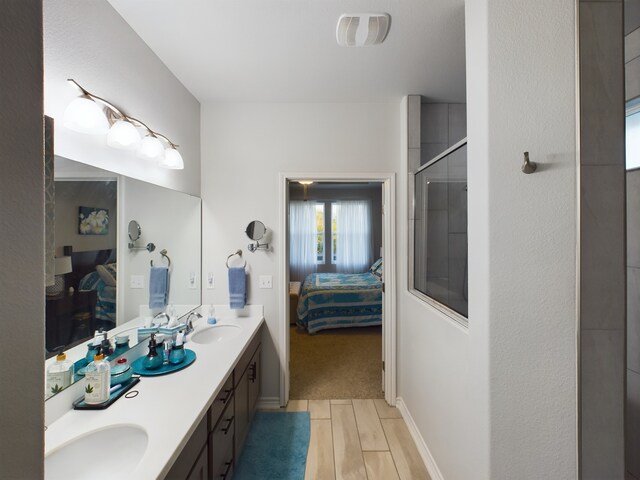 bathroom with an enclosed shower and vanity