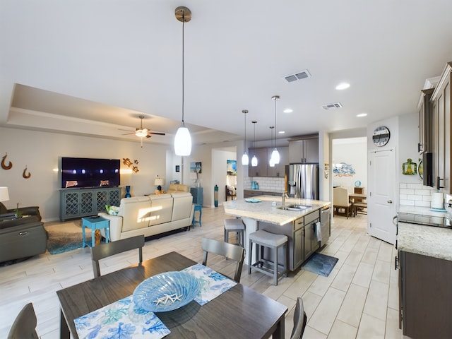 dining room with sink and ceiling fan