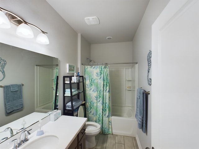 full bathroom with shower / tub combo, toilet, and vanity