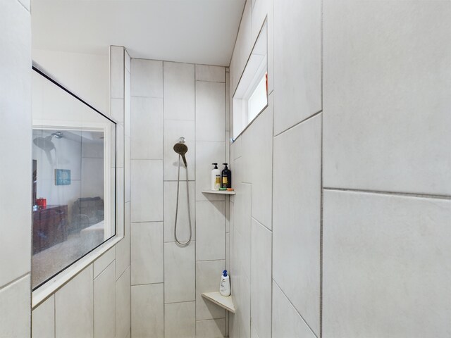 bathroom with tiled shower