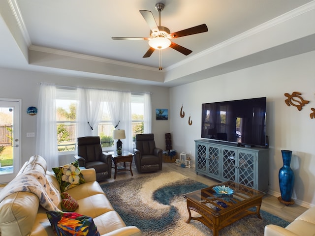 living room featuring ornamental molding, a healthy amount of sunlight, ceiling fan, and wood-type flooring