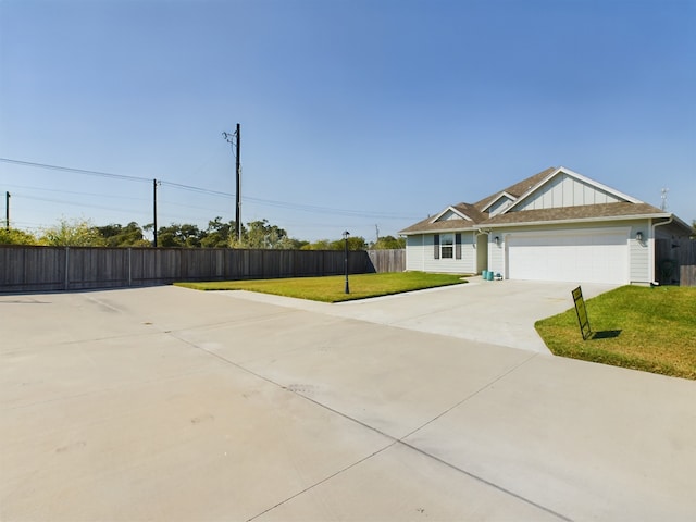 view of front of house with a garage and a front yard