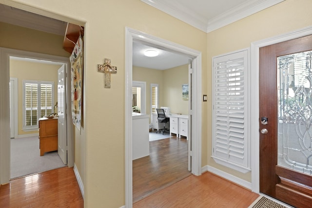 entryway featuring hardwood / wood-style floors and ornamental molding