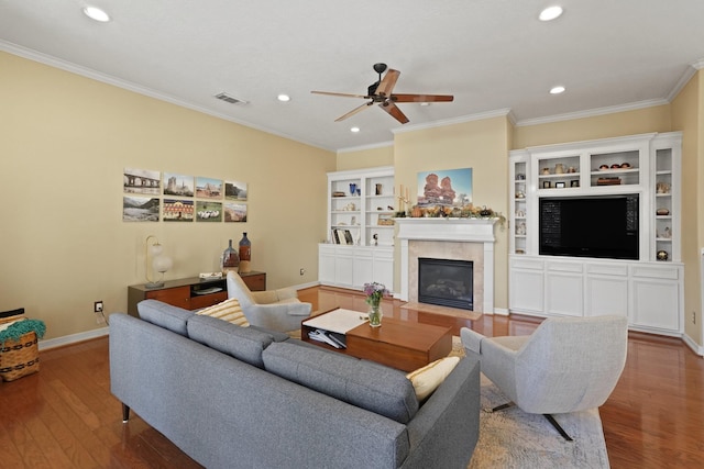 living room featuring ceiling fan, ornamental molding, and hardwood / wood-style flooring