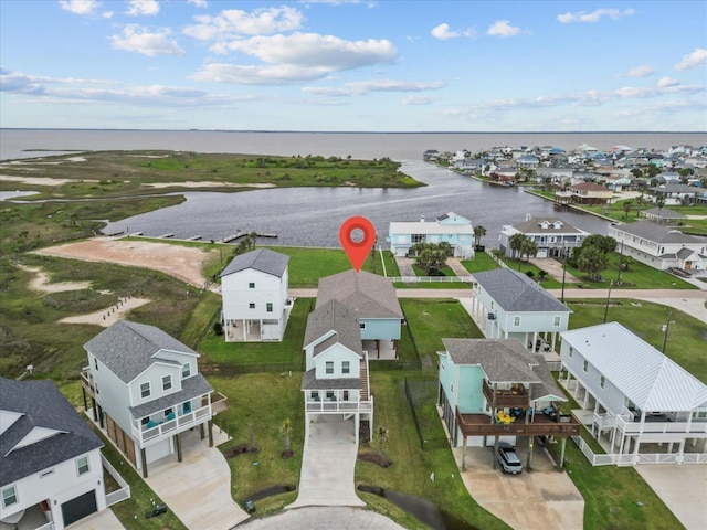 birds eye view of property with a water view and a residential view