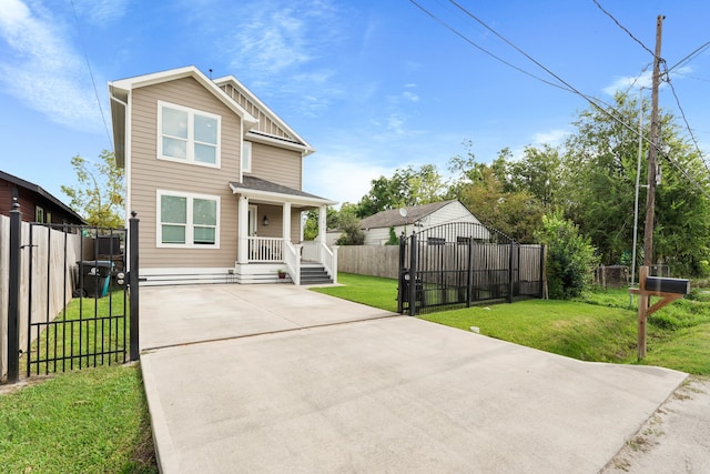 view of front facade with a front yard and covered porch