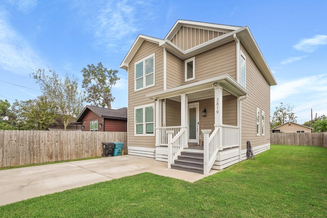 view of front of property with covered porch and a front lawn