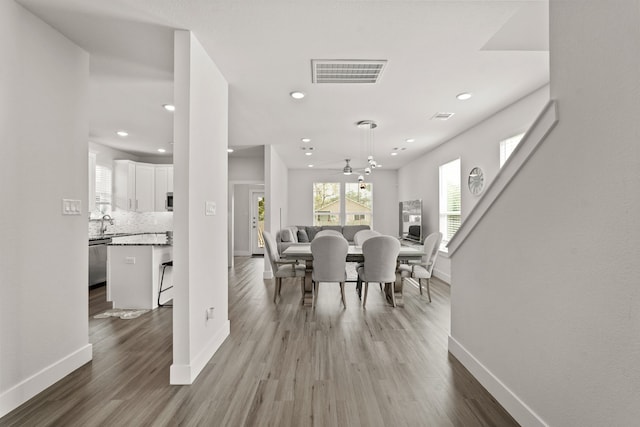 dining room with hardwood / wood-style flooring and ceiling fan