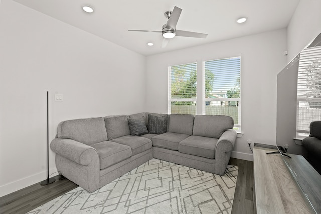 living room with light hardwood / wood-style floors and ceiling fan