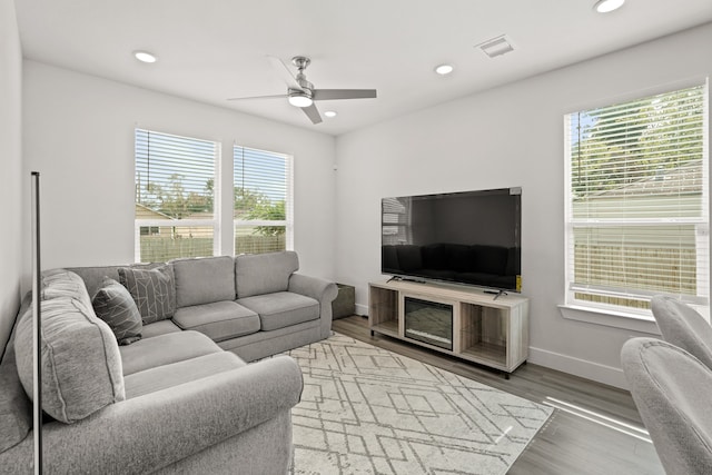 living room featuring hardwood / wood-style flooring and ceiling fan