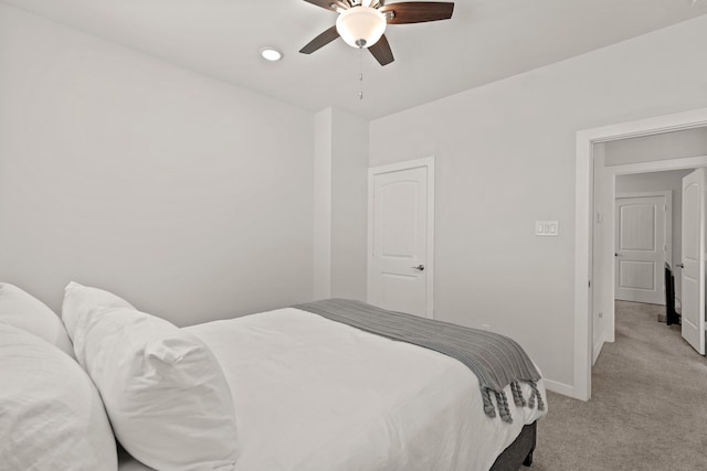 bedroom with ceiling fan and light carpet