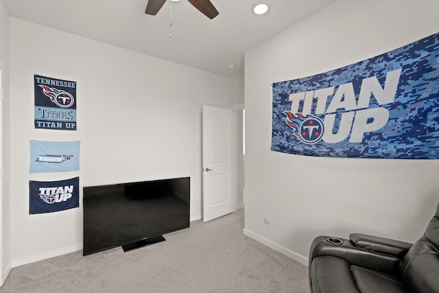 sitting room with ceiling fan and light carpet