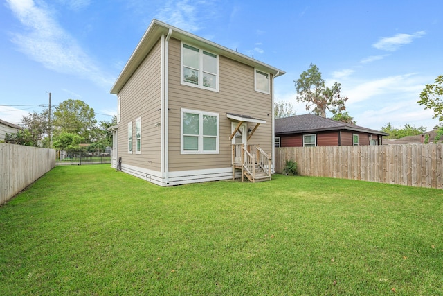 back of property featuring a lawn