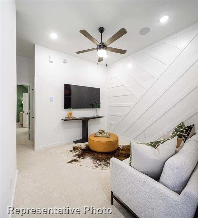 living room featuring carpet floors and ceiling fan