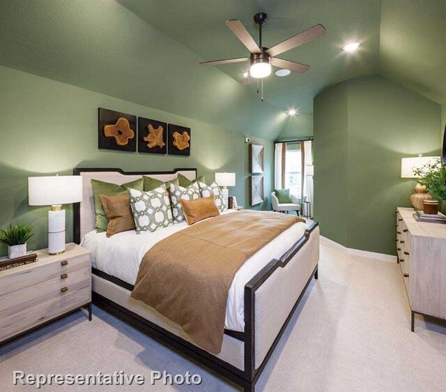 carpeted bedroom featuring lofted ceiling and ceiling fan