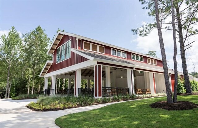 back of property featuring a porch, a lawn, and ceiling fan