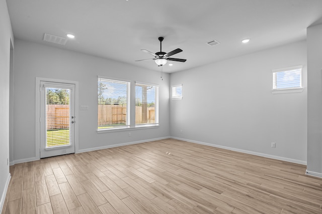 spare room featuring light wood-type flooring and ceiling fan