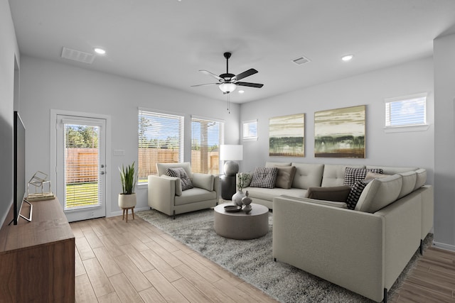 living room featuring wood-type flooring and ceiling fan