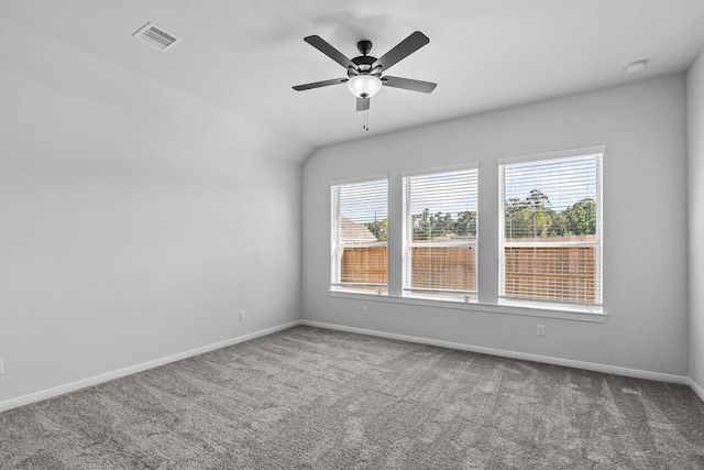 empty room featuring ceiling fan, carpet floors, and plenty of natural light