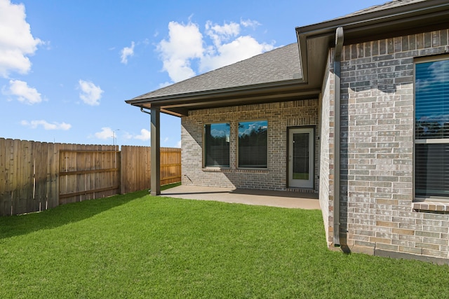 back of property featuring a patio and a lawn