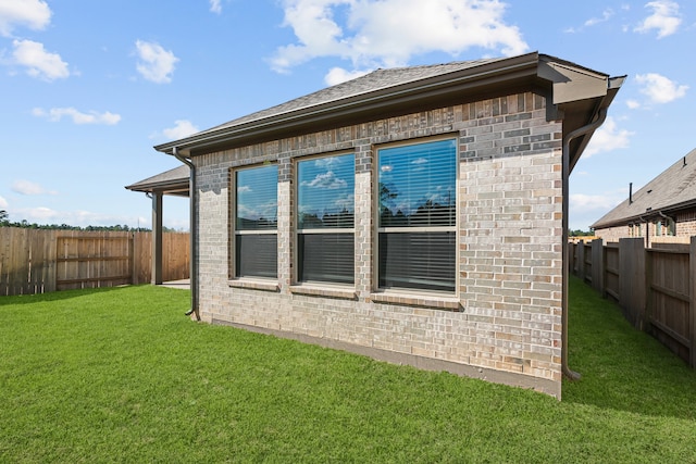 view of home's exterior with a lawn