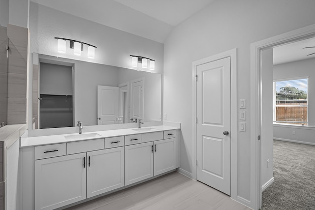 bathroom with vanity, vaulted ceiling, and ceiling fan