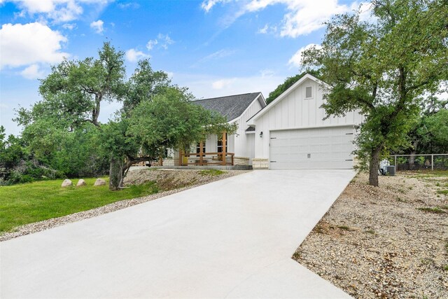 view of front of property featuring a garage and a front lawn