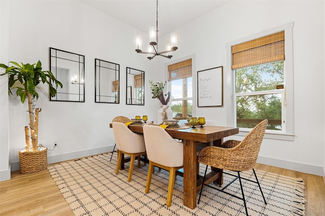 dining room with an inviting chandelier and light wood-type flooring