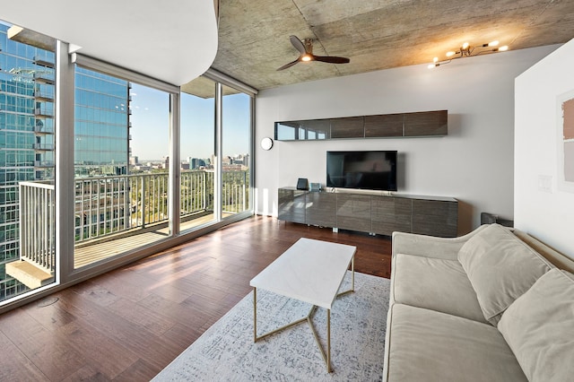 living room with wood-type flooring, floor to ceiling windows, and ceiling fan