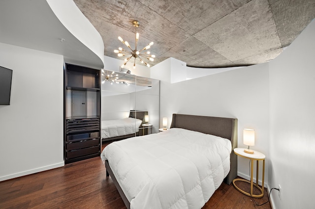 bedroom with an inviting chandelier and dark wood-type flooring