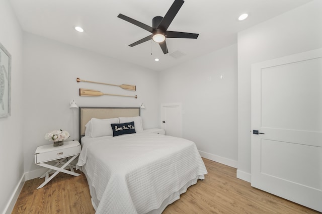 bedroom with ceiling fan and light hardwood / wood-style flooring