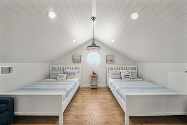 bedroom with light hardwood / wood-style flooring and vaulted ceiling