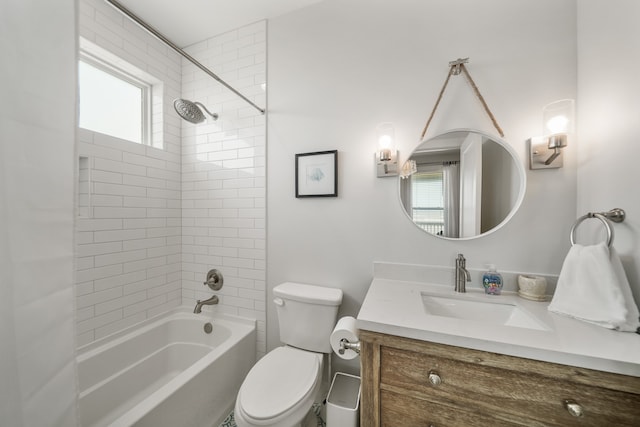 full bathroom featuring vanity, toilet, and tiled shower / bath