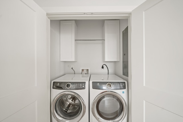 washroom with independent washer and dryer and cabinets